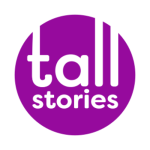 The Tall Stories logo: A purple circle on a white background with the words 'tall stories' in the centre. The 't' and two 'l's' of the word 'tall' is stretched tall to the top of the circle. All letters are in lowercase.
